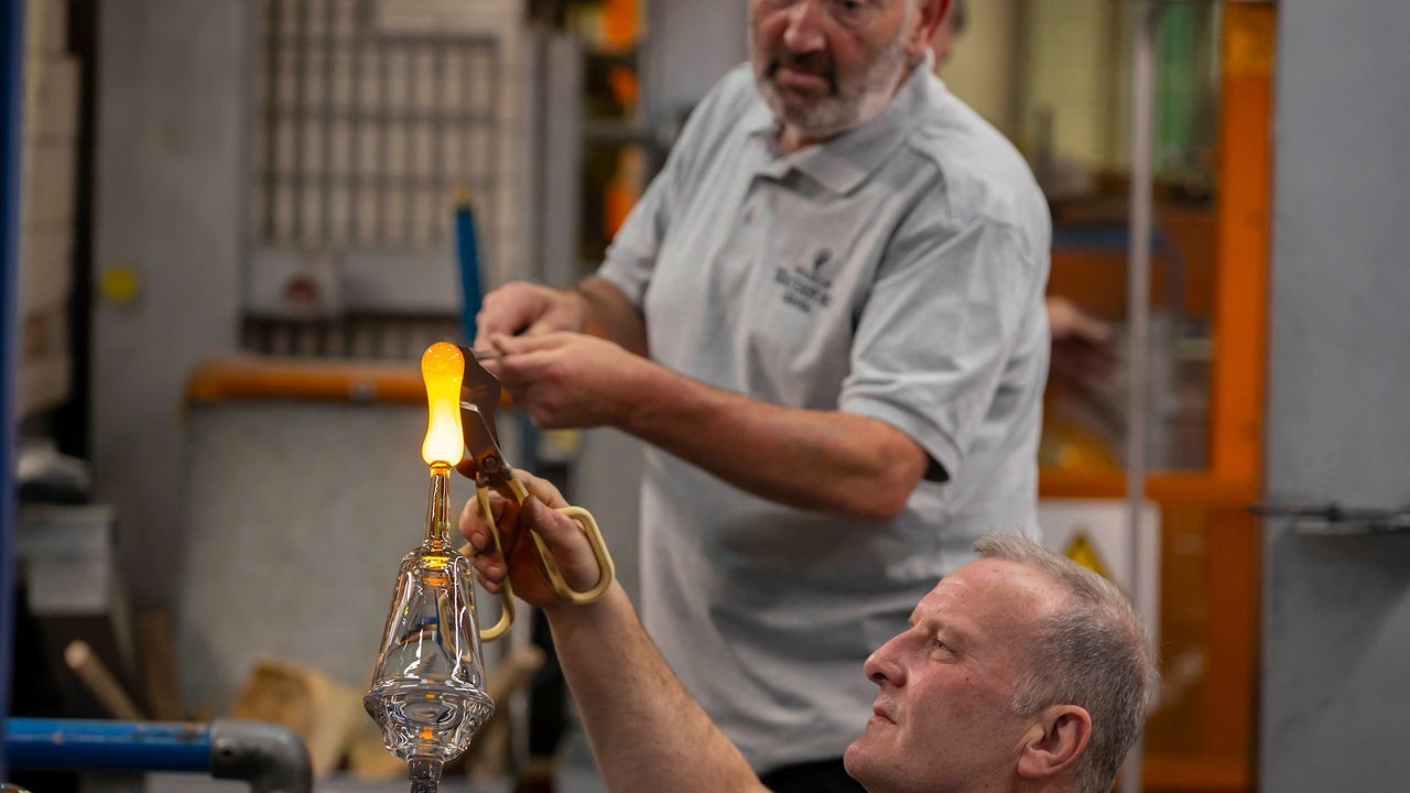 Master blowers transforming balls of crystal into shapes at The House of Waterford Crystal Factory
