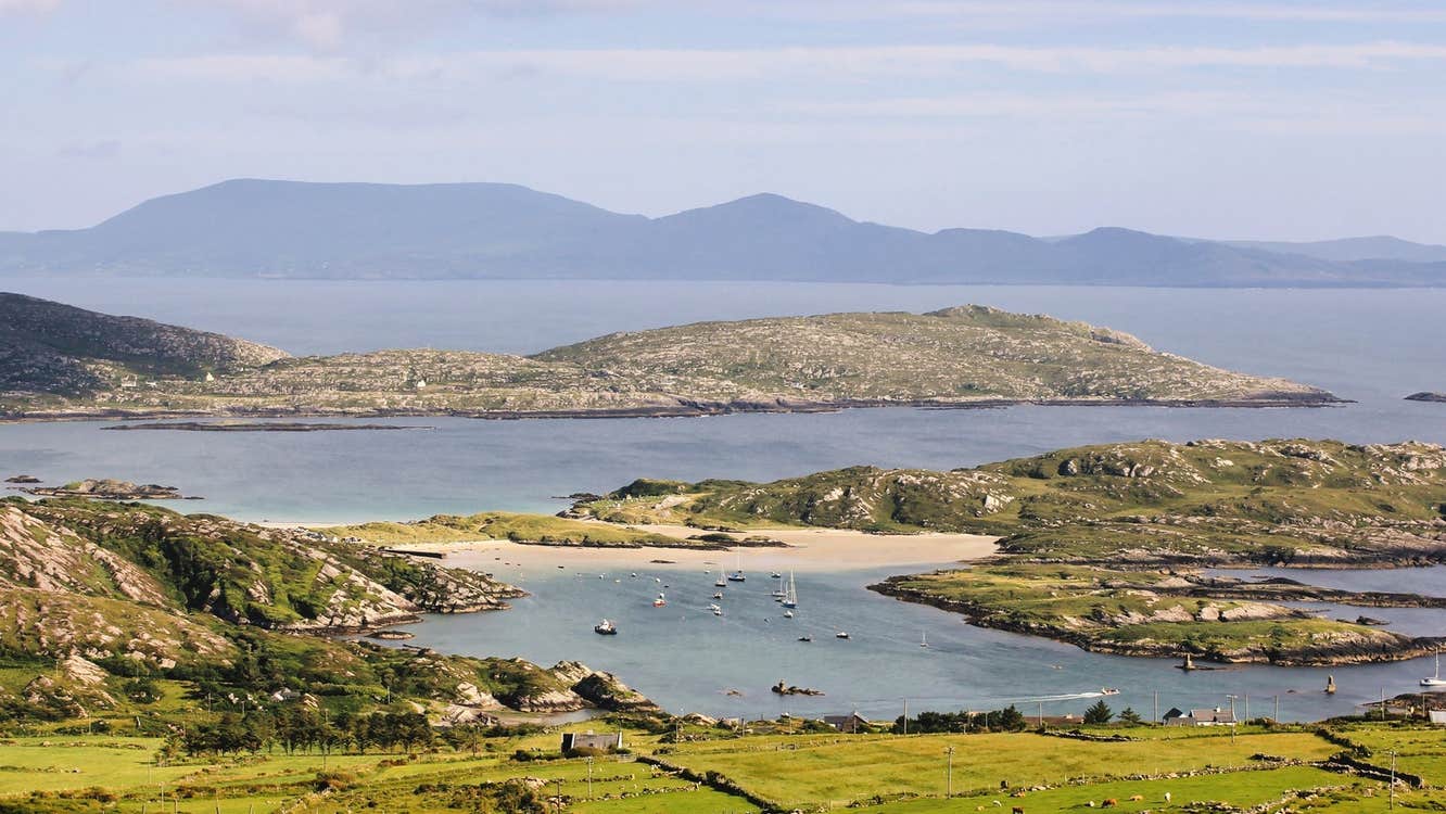 A coastal view with a headland and beach in the distance
