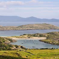 A coastal view with a headland and beach in the distance