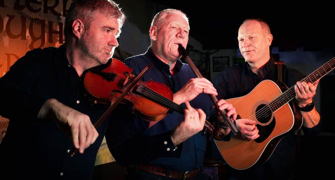 Group of three traditional Irish musicians playing at The Merry Ploughboy pub in Rathfarnham, Dublin.