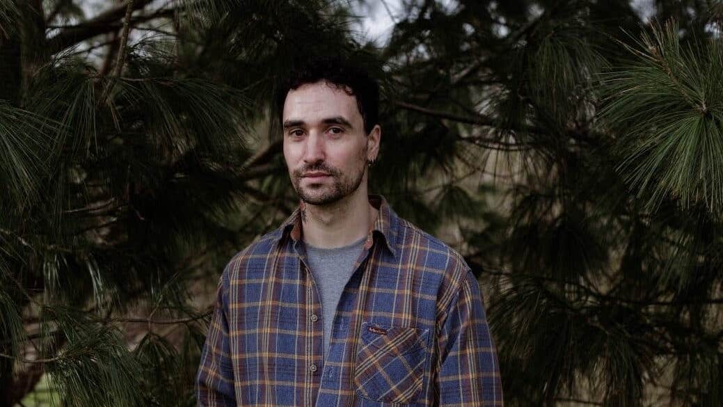 A conversation with Djamel White, a serious looking man in a checked shirt