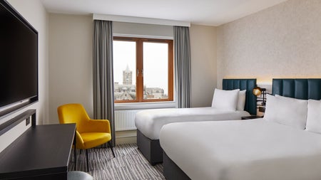 Twin bedroom with white sheets