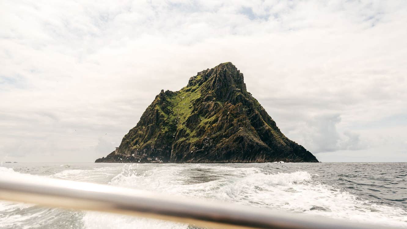 Skellig Michael surrounded by water as seen from a boat
