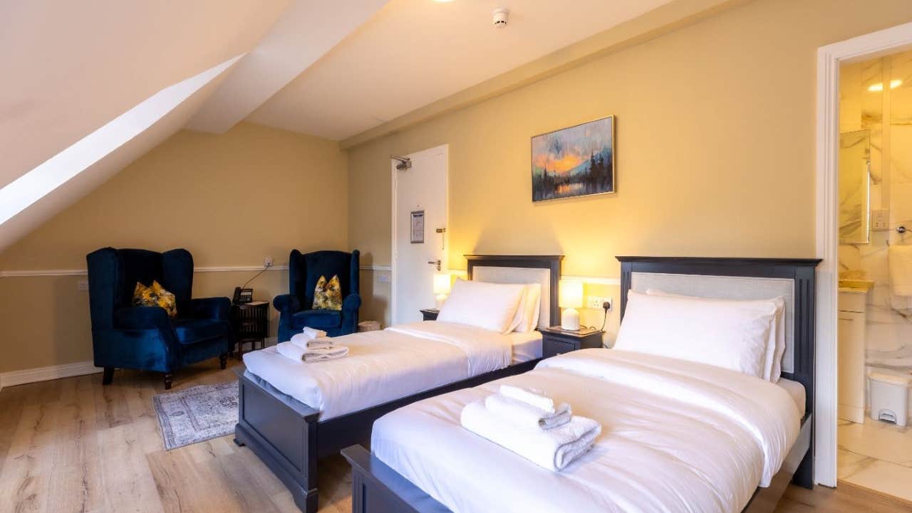 Bedroom with two beds and seating area