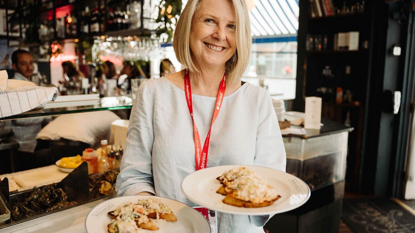 A lady holding two plates of food