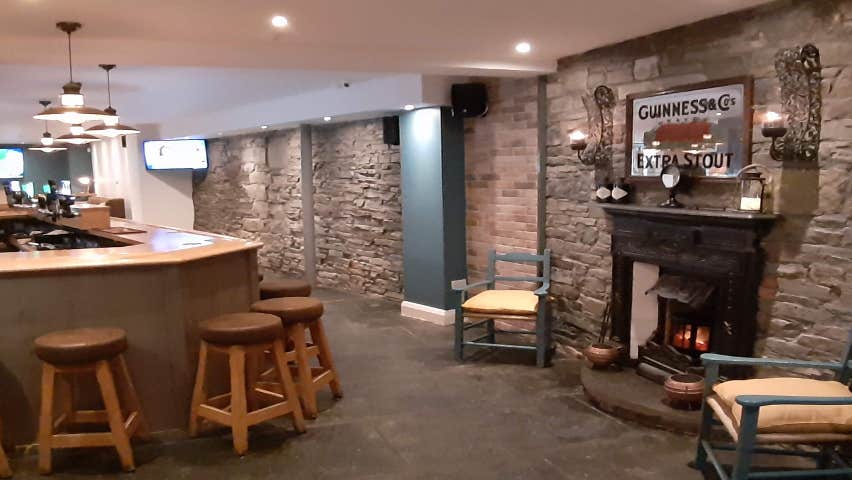 View of the fireplace and bar