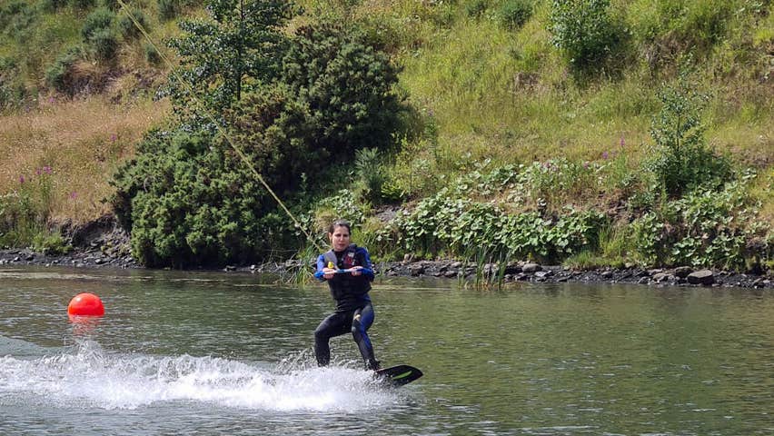 Image of a girl wakeboarding on a lake