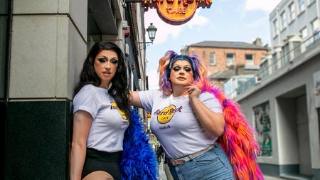 Drag brunch misses standing under café sign