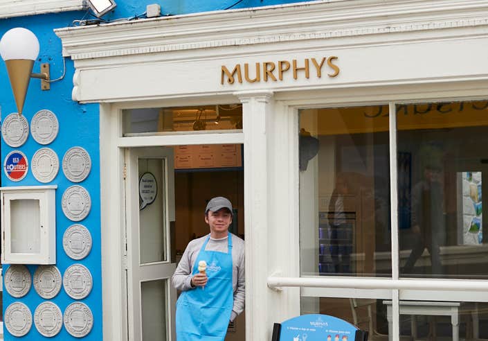 A man standing outside of Murphy's ice-cream shop in Dingle, County Kerry