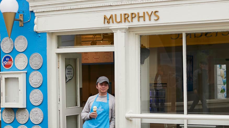 A man standing outside of Murphy's ice-cream shop in Dingle, County Kerry