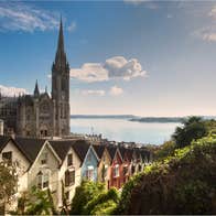 St Colman's Cathedral beside a row of colourful houses