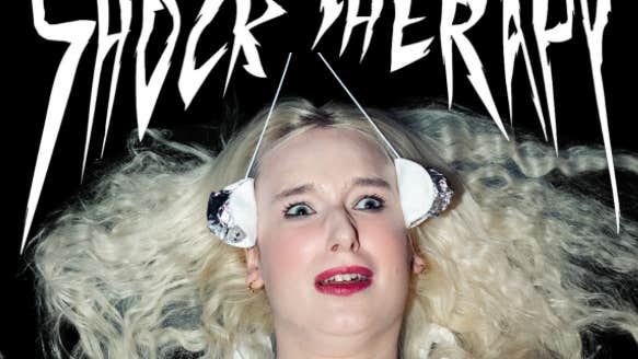 A shocked looking woman with white blonde hair