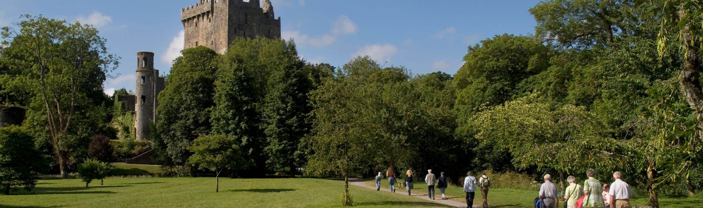 A group of people walking towards Blarney Castle in County Cork