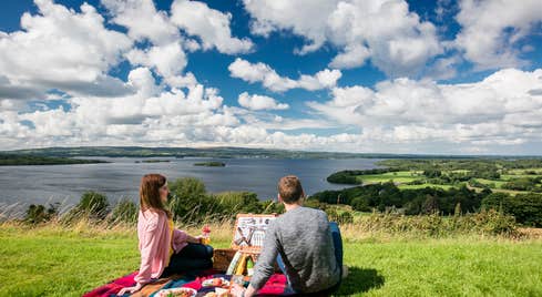 A couple having a picnic while looking out at Lough Derg in County Tipperary.
