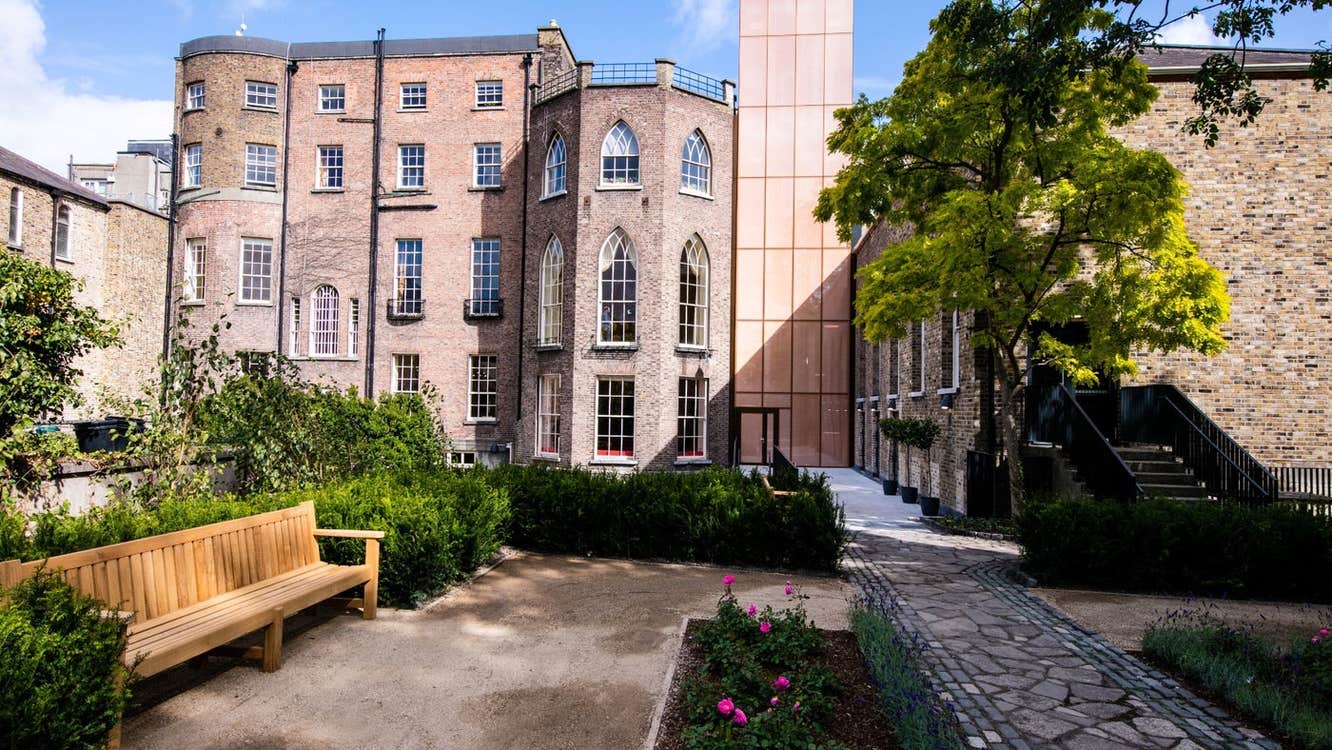Three storey period building overlooking a garden