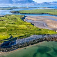 An aerial view of Tralee Golf Club golf course and surrounding coastal scenery