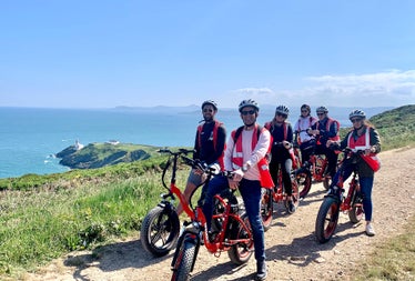 A group on bikes on a coastal path