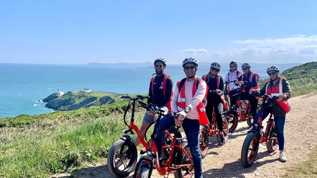 A group on bikes on a coastal path