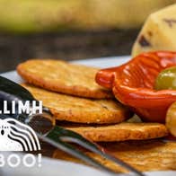 Féasta Fómhair / Harvest Feast, partial view of a platter of food including crackers, cheese and olives.
