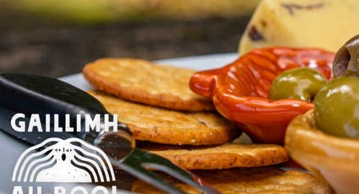 Féasta Fómhair / Harvest Feast, partial view of a platter of food including crackers, cheese and olives.