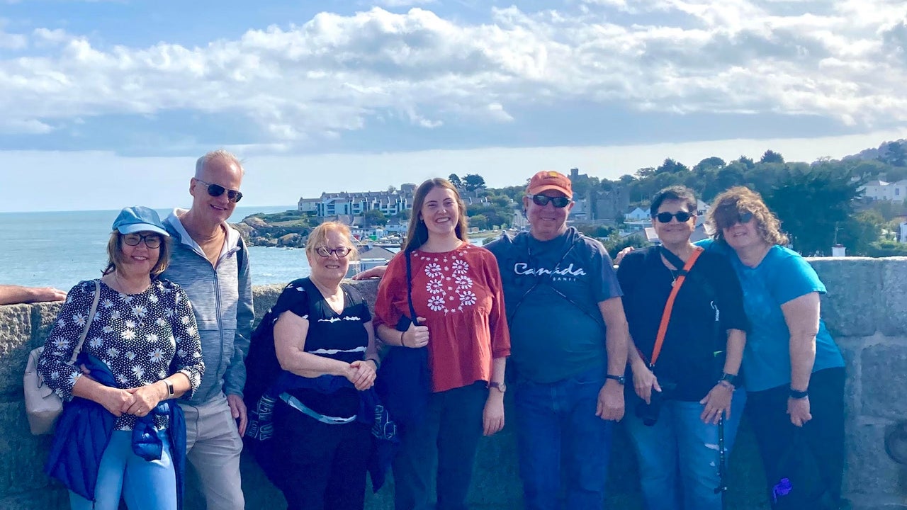 A group of people with their tour guide on a Dublin Coastal Tour