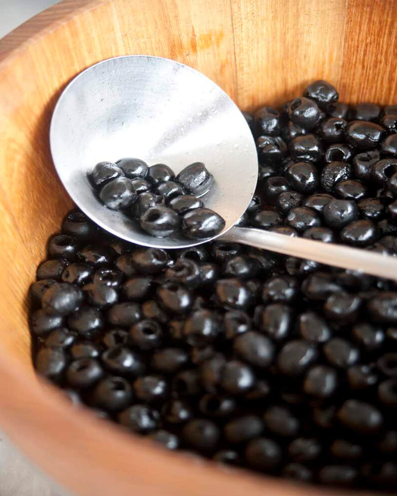 Wooden tub full of black olives at Temple Bar Food Market in Dublin.