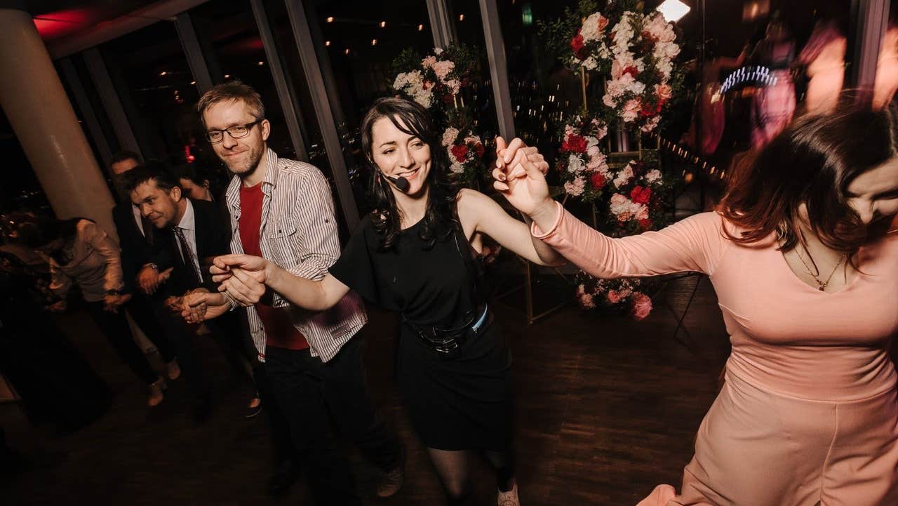 A group of people and their host doing Irish dancing