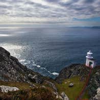 A lighthouse on Sheep's Head in County Cork overlooking the deep blue sea