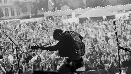A guitarist rocks a cheering crowd at the Tailteann Games music stage. With traditional and contemporary Irish music, the festival brings ancient spirit into a modern, vibrant cultural celebration.