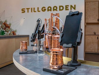 Stillgarden Distillery gin school showing copper equipment and cups with tablets