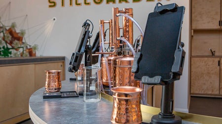 Stillgarden Distillery gin school showing copper equipment and cups with tablets