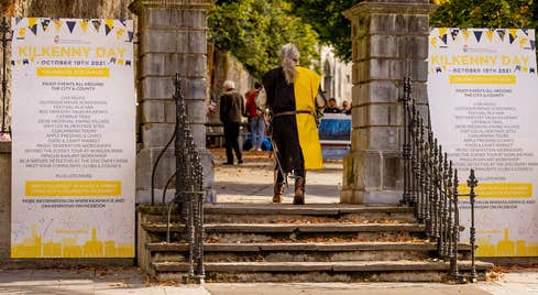 Kilkenny Day 2022 in Kilkenny City, a man dressed as a knight walking through a gate