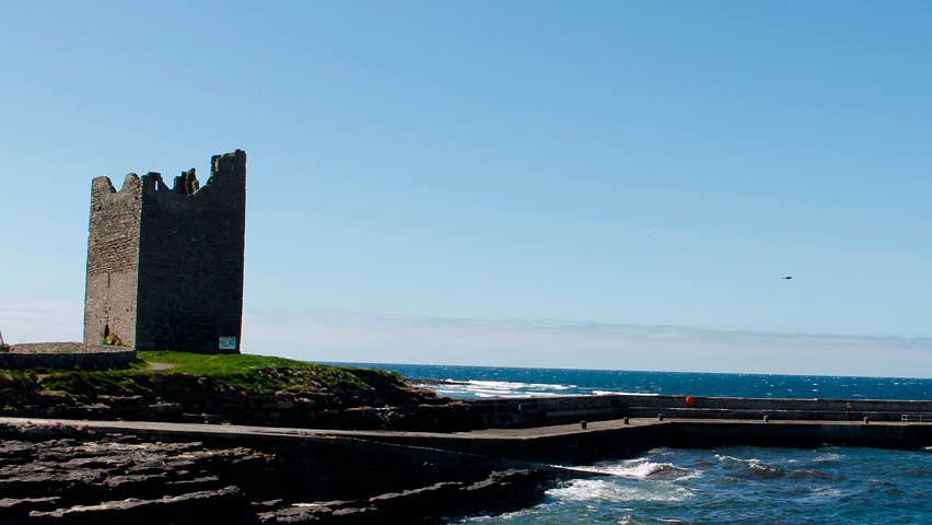 The ruins of a tower overlooking a pier