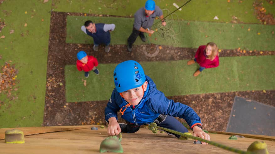 A little boy rock climbing at Russborough House and Parklands in County Wicklow.