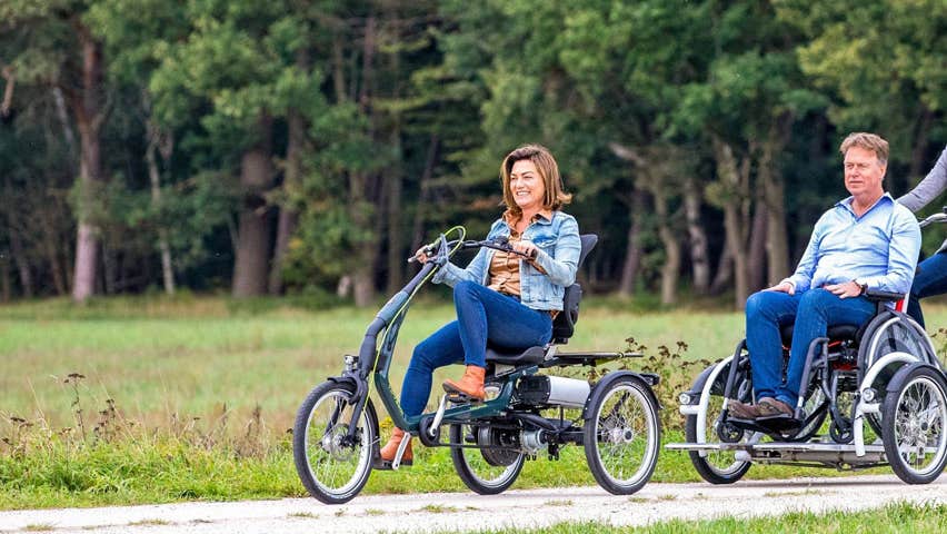 Three people cycling on three different types of bicycle