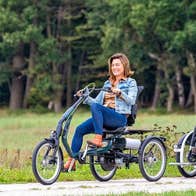 Three people cycling on three different types of bicycle