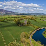 An aerial image a river winding through open fields