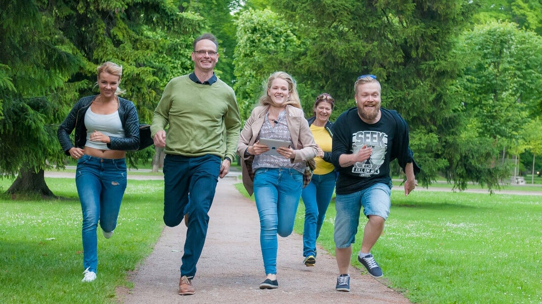 Group of five running through park