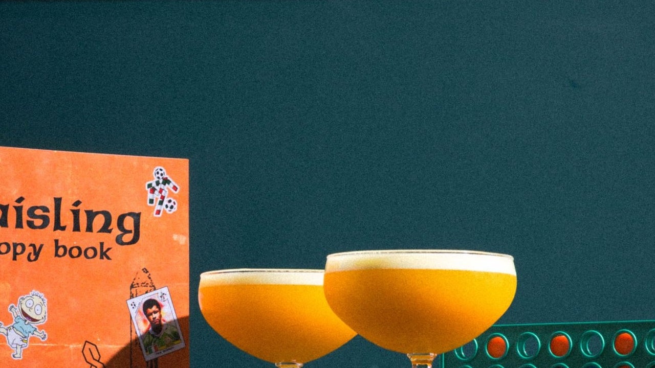 Two glasses of a Solero inspired cocktail with a retro backdrop
