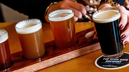 A tasting tray with four sample sizes of different beers