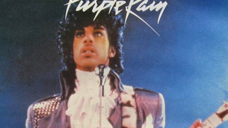 When Doves Cry: A Prince Film Night, a man on a stage playing a guitar with a worried look on his face.