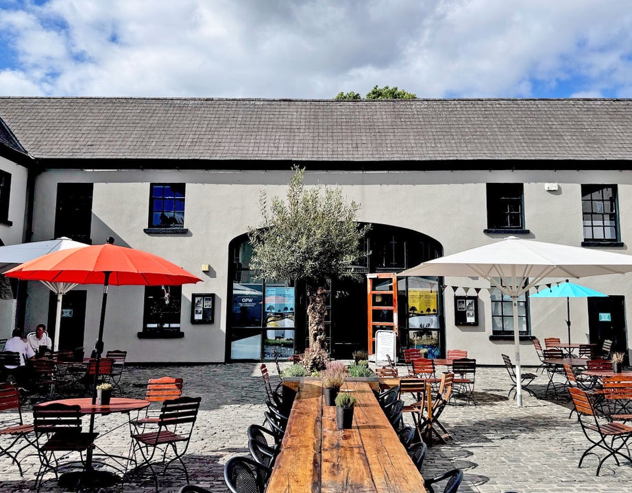 Phoenix Park Café exterior courtyard with table and umbrellas