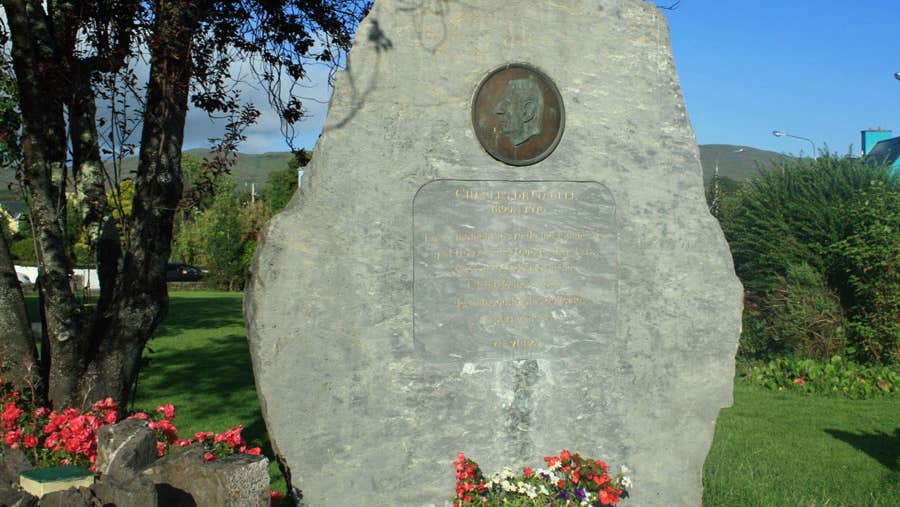 A large limestone boulder bearing an inscription and a bronze inlaid plaque of President Charles De Gaulle