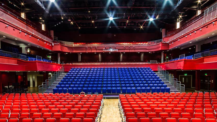 A view from a stage onto the empty seating of a theatre