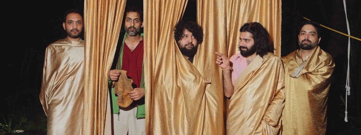 5 men with dark beards, some partially obscured by gold curtains hanging down from a wire above their heads.