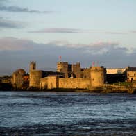 King Johns Castle surrounded by water on a cloudy day in County Limerick