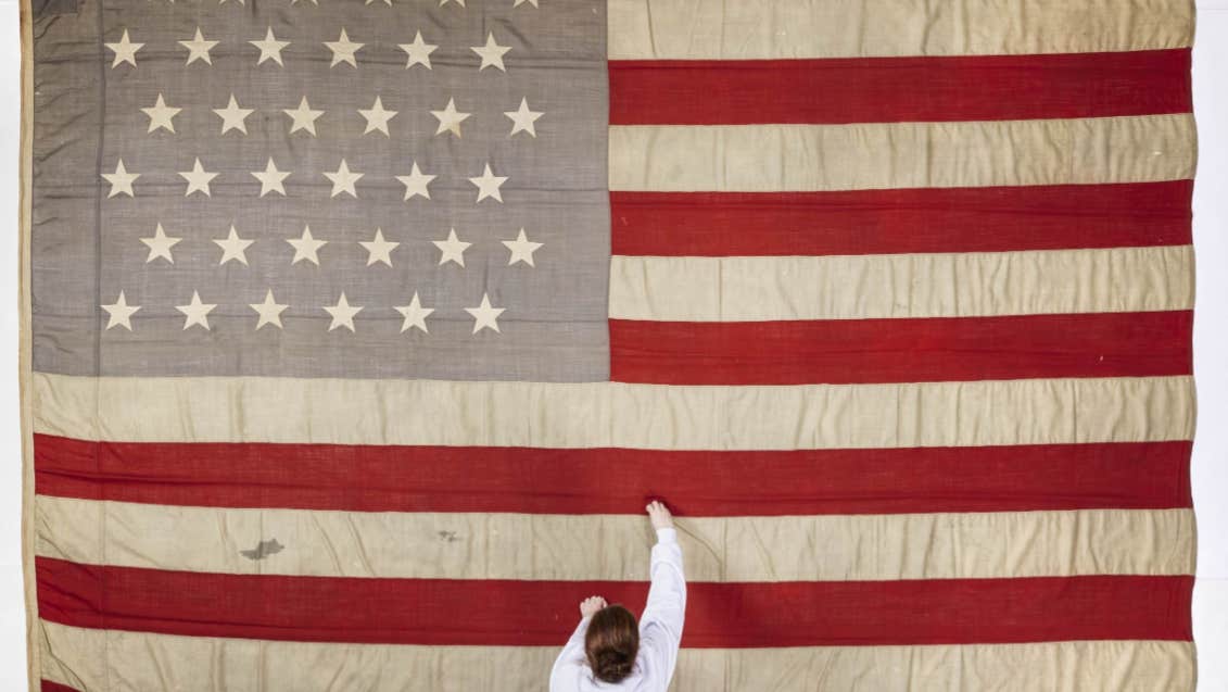 The flag of the Catalpa, with National Museum of Ireland Textile Conservator Lorna Rowley. Image © National Museum of Ireland