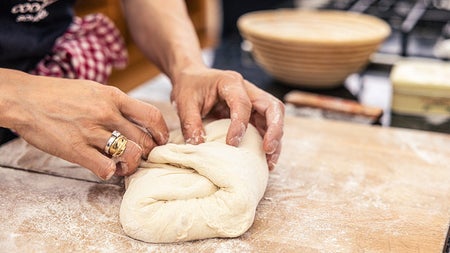 Dough being kneaded on a board
