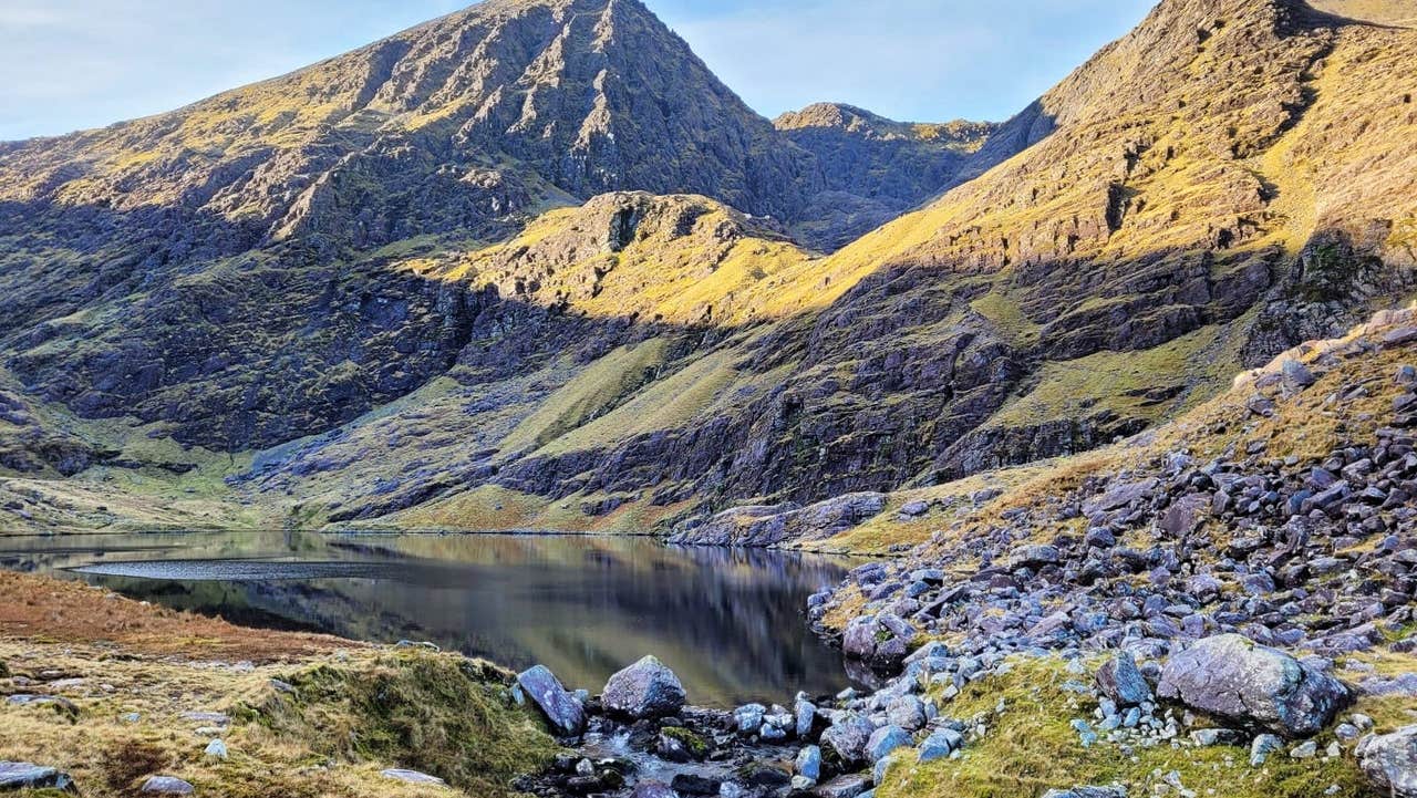 A view of a mountain with a rocky and boggy landscape