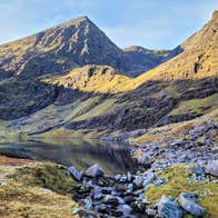 A view of a mountain with a rocky and boggy landscape